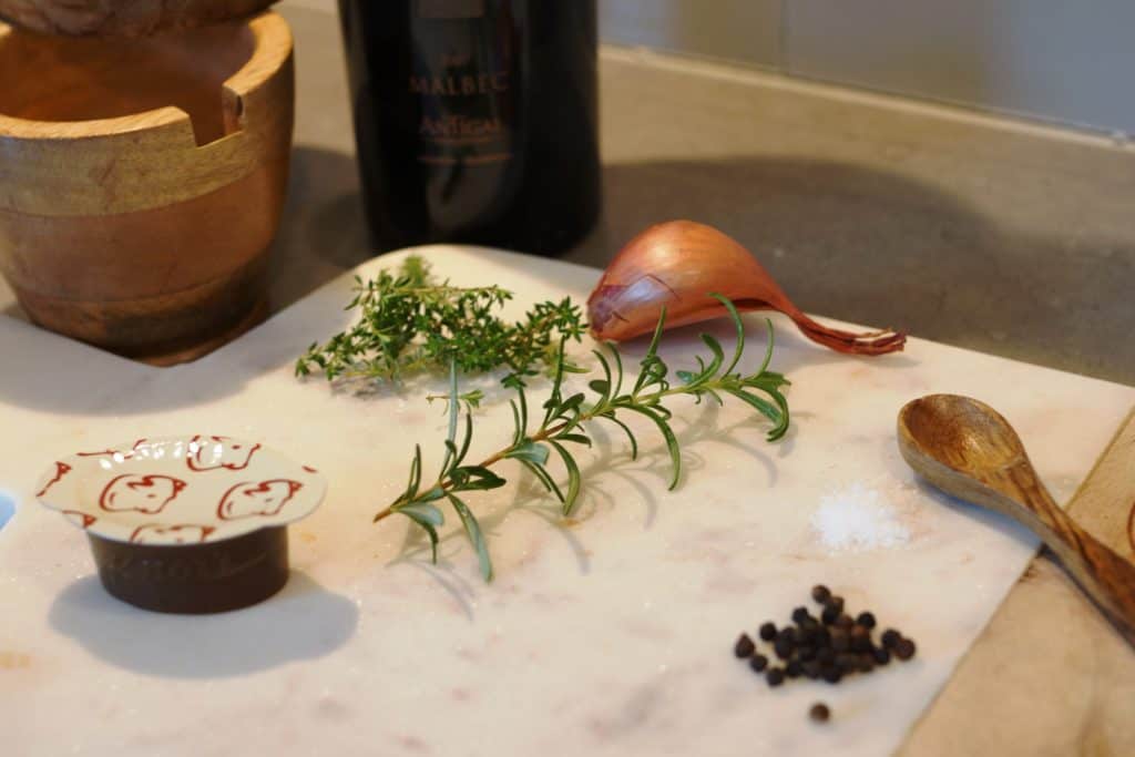 Ingredients needed to make the Malbec sauce, arranged on a cutting board.