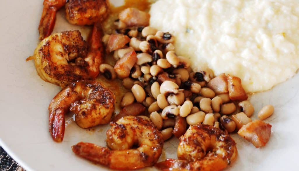 Cajun BBQ shrimp with black eyed peas and cheese grits.