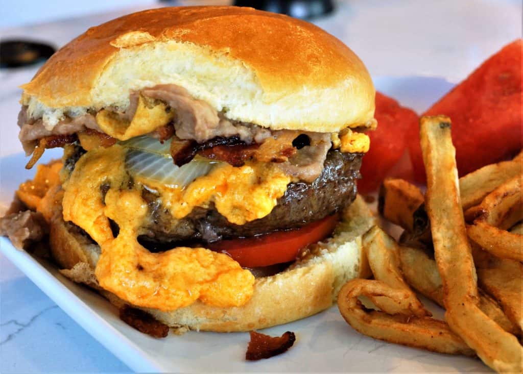 San Antonio style bean burger with melted cheese and bacon.