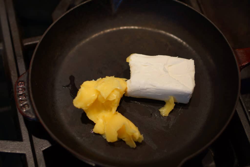 Lard and clarified butter in a large skillet.