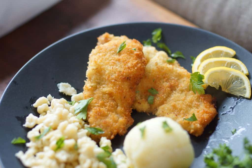 Authentic Austrian style wiener schnitzel made with veal, served with spätzle and potato dumplings.