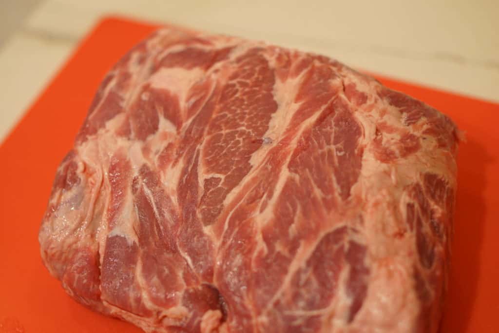 Pork butt on a cutting board.