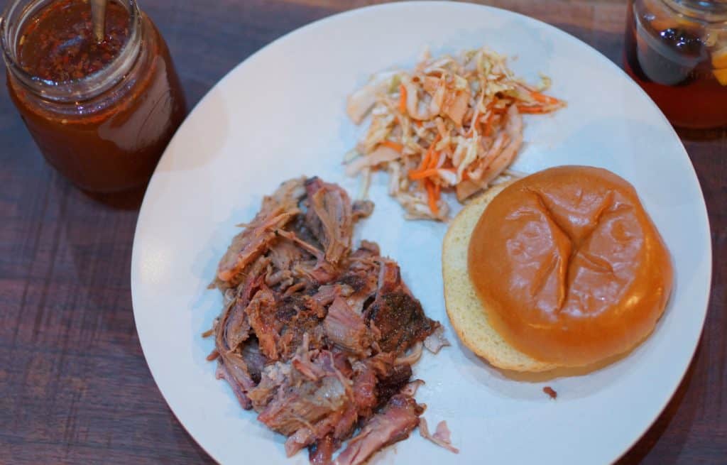 Pulled pork served with slaw and a bun.