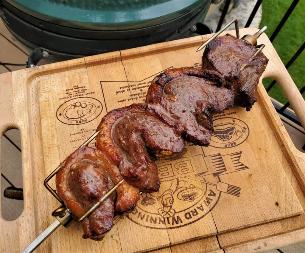 Skewered Brazilian steakhouse style picanha on a cutting board.