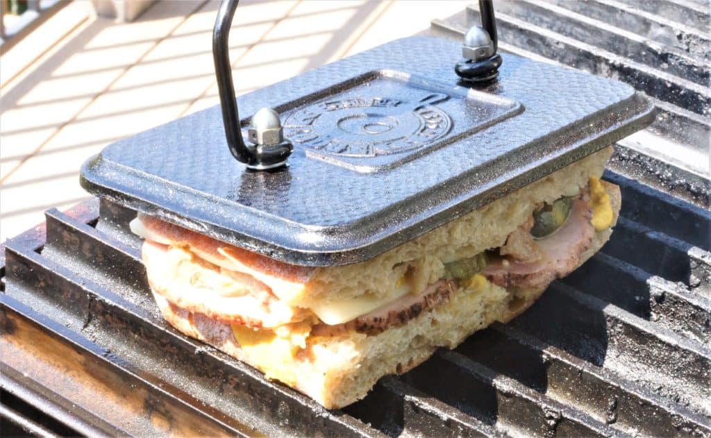 Making a grilled Cuban panini on a PK grill.
