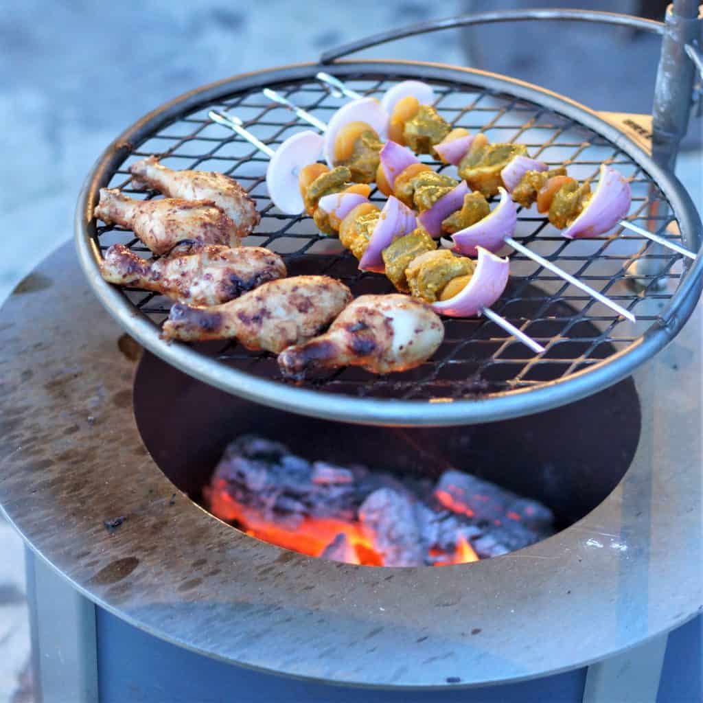 Lamb and apricot sosaties and peri peri chicken cooking on a Breeo firepit.