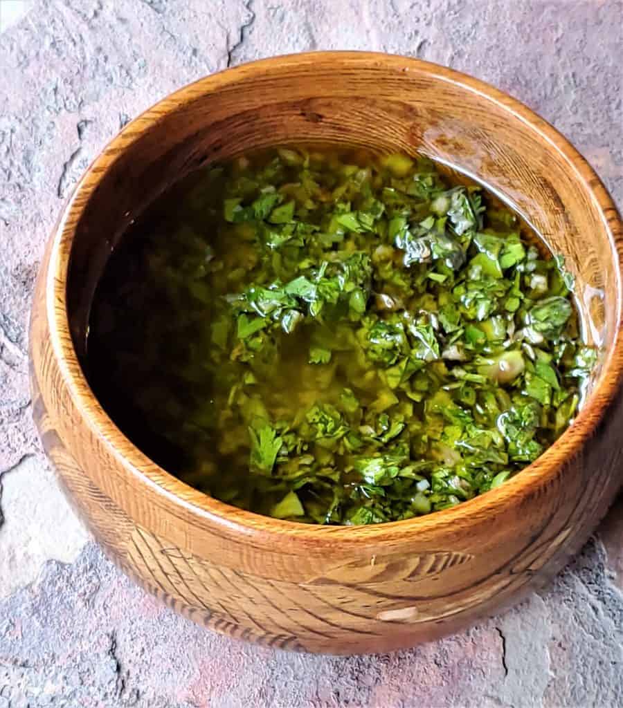 Wooden bowl with chimichurri sauce.