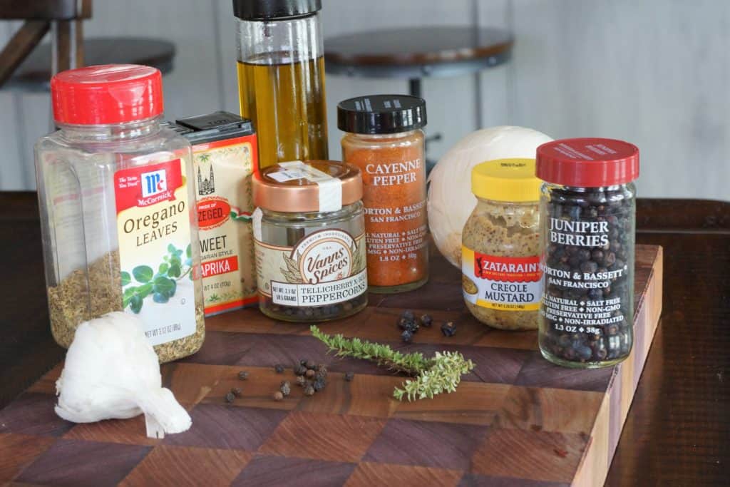 Assorted spices and seasonings on a wood board.