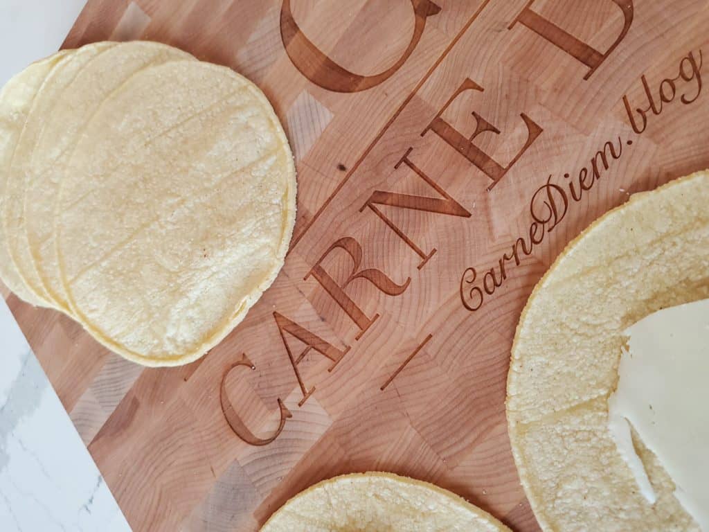 Corn tortillas on a cutting board reading Carnediem.blog.