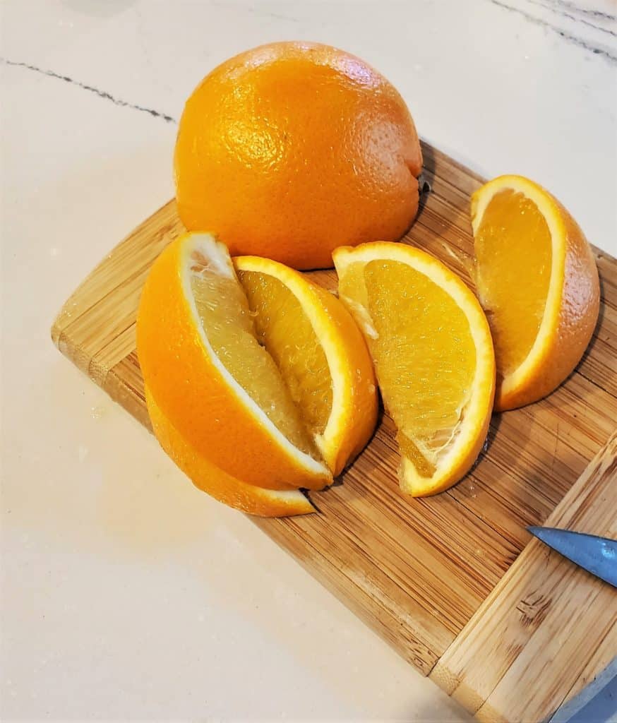 Oranges on a cutting board.