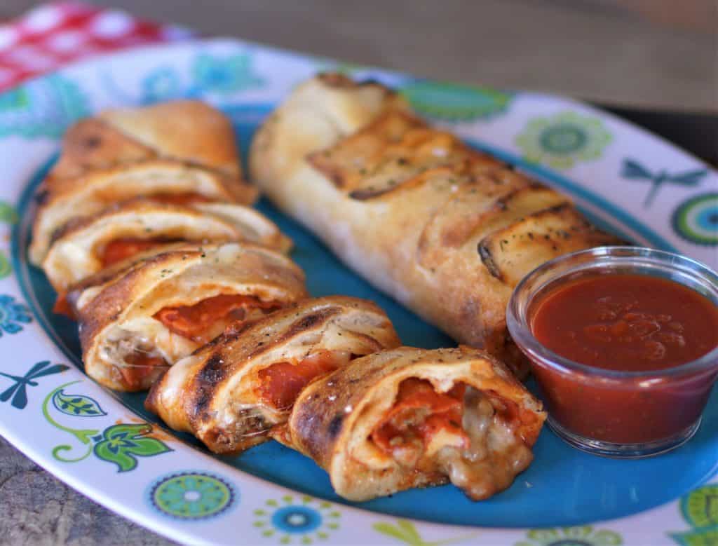 Sausage and pepperoni stromboli  cut into slices on a plate