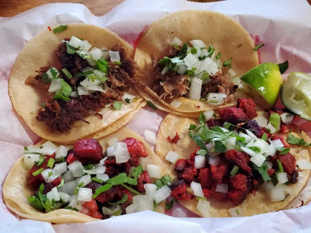 Taqueria style tacos on a plate.