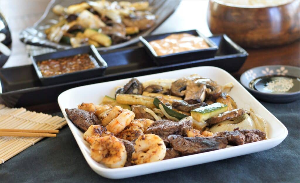 Teppanyaki steak and shrimp served with dipping sauces.