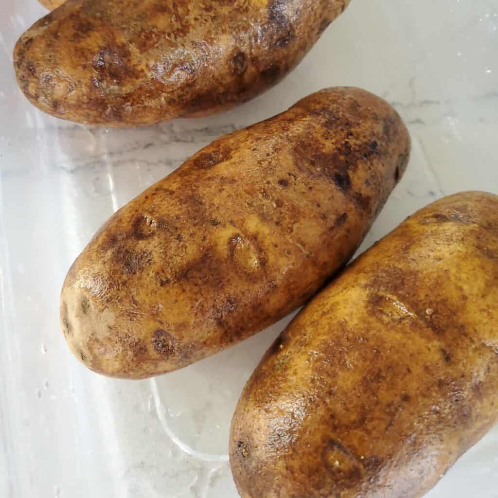 Rinsed russet potatoes.