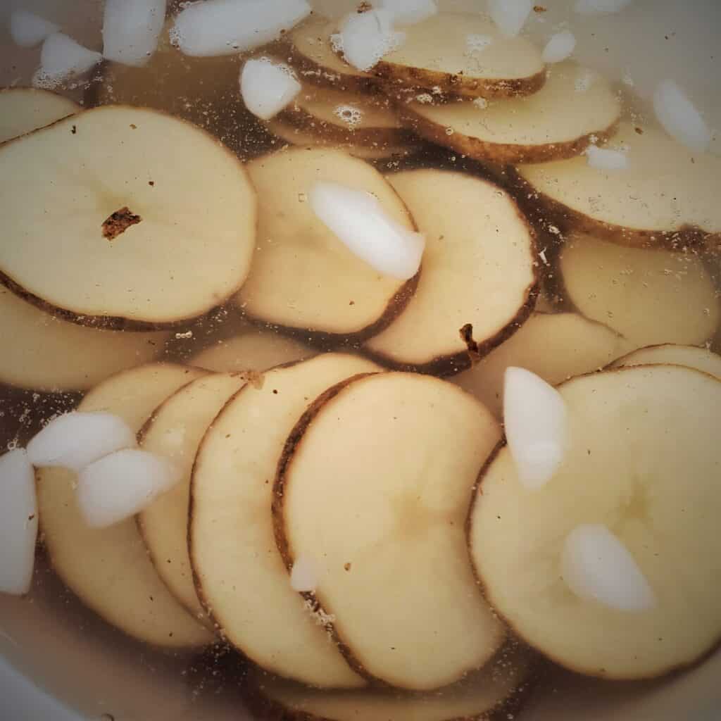 Potato slices soaking in ice water.