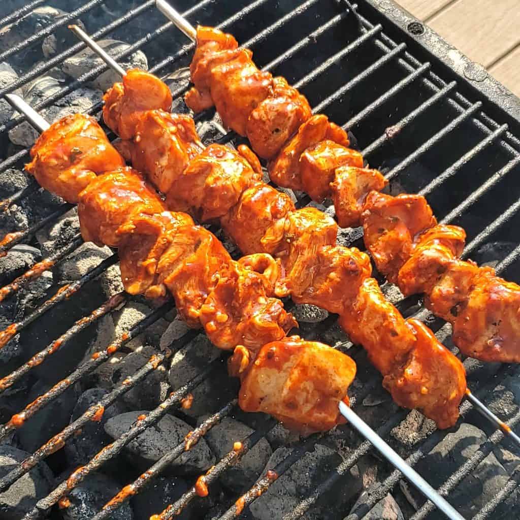 Grilled Peruvian chicken skewers on a PK Grill.