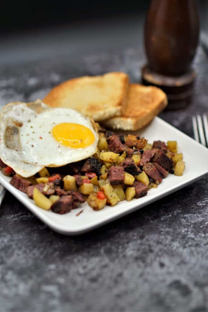 Brerakfast Pastrami Hash topped with a fried egg.