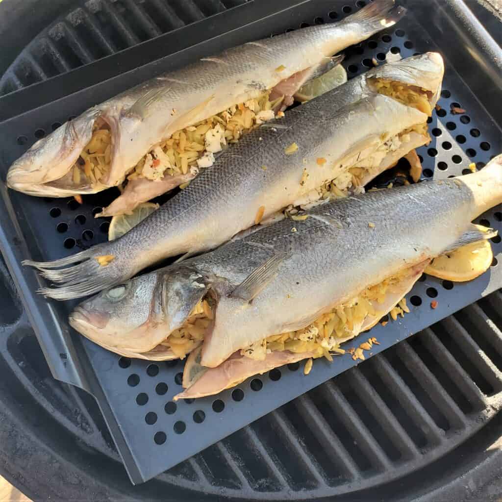 3 stuffed branzino on a Big Green Egg BBQ grill.