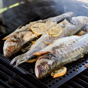 Branzino stuffed with feta and orzo on a grill