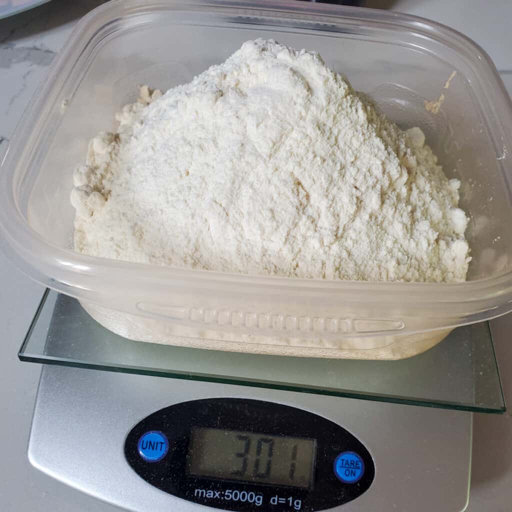 300 grams of flours weighed on a scale.