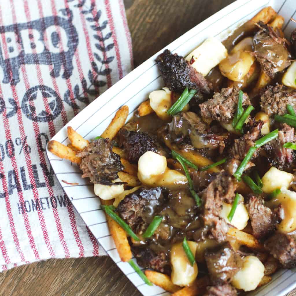 BBQ poutine on a stiped plate.