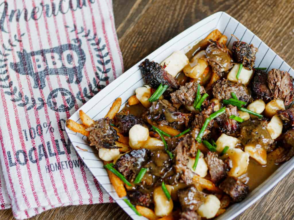 Plate of smoked brisket BBQ poutine.