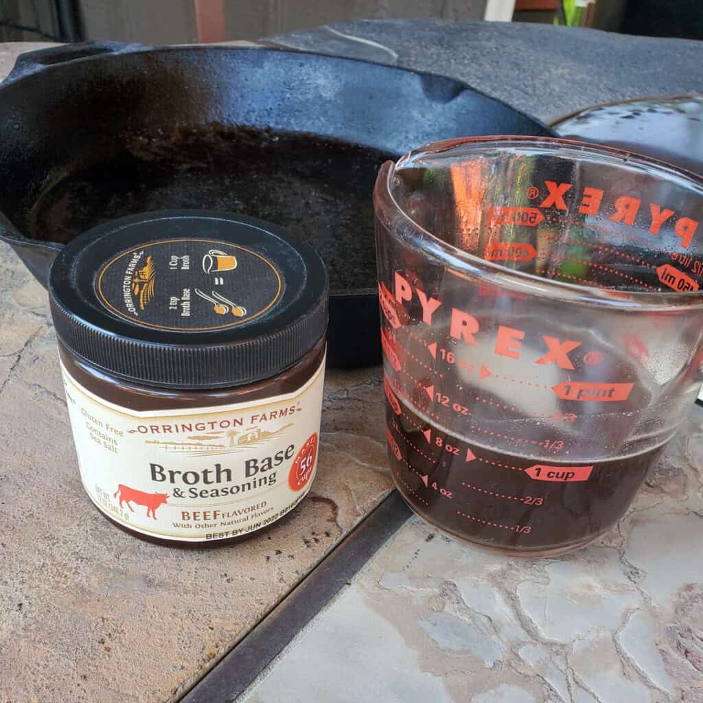 Measuring cup with beef bone broth.