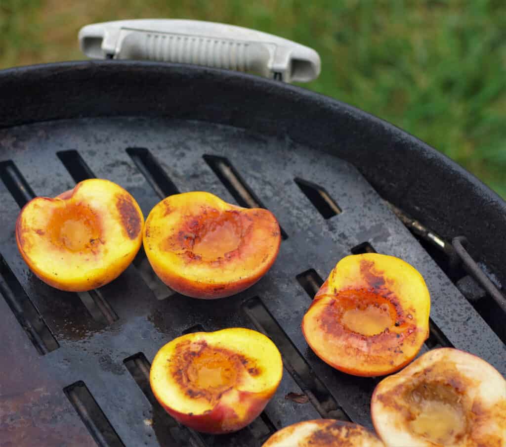 Peaches grilling on a Weber Grill.