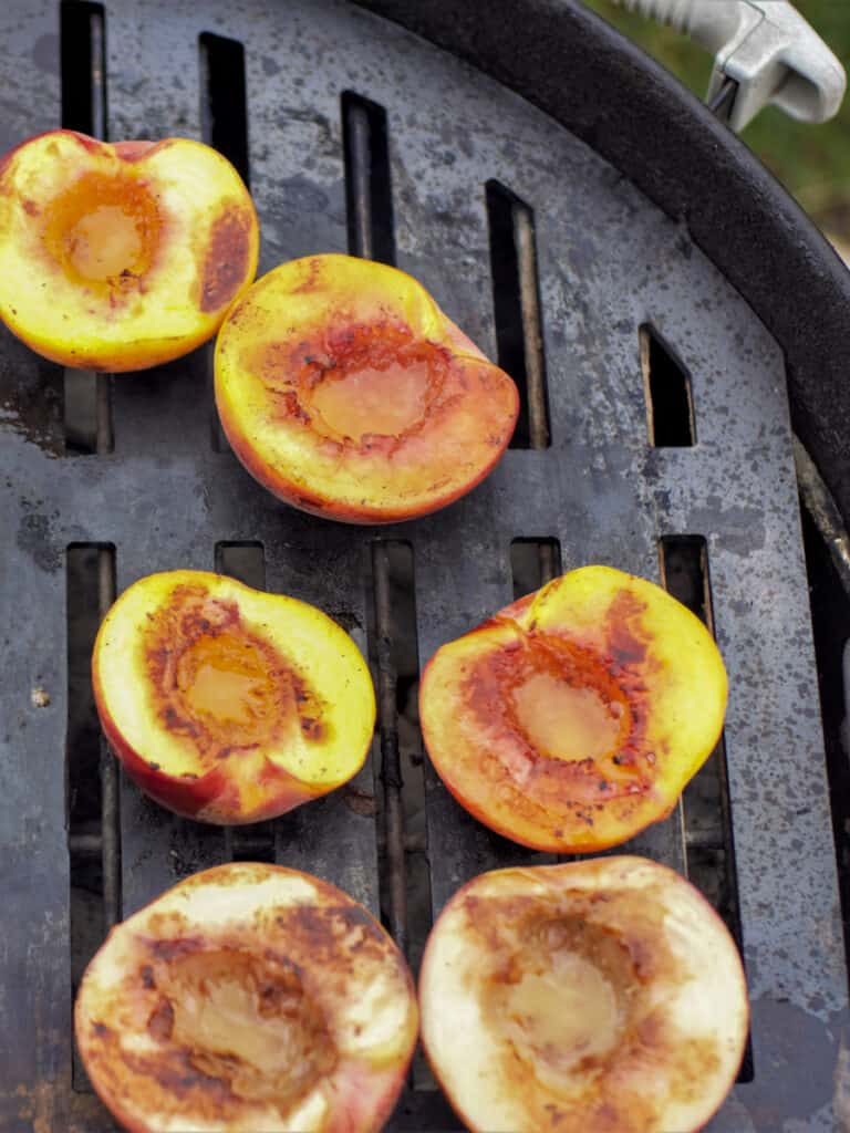Grilled peaches on a Weber kettle with a Cooking Steel.