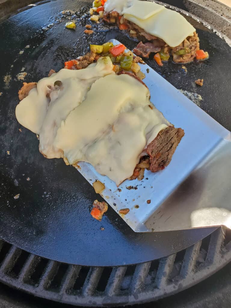 Philly cheesesteak on a flat top griddle.