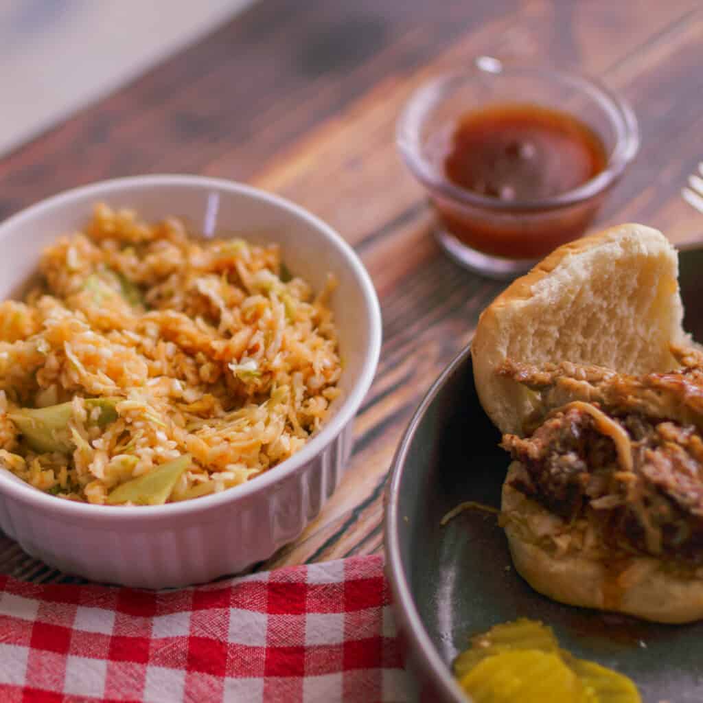 Bowl of Lexington Style Red Coleslaw with a pulled pork slider.