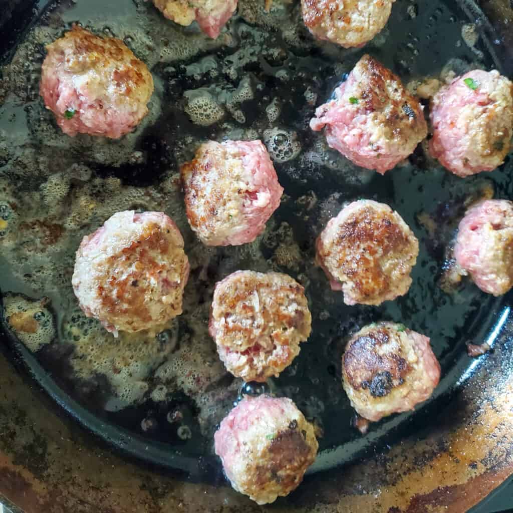 Swedish Meatballs cooking in a cast iron pan