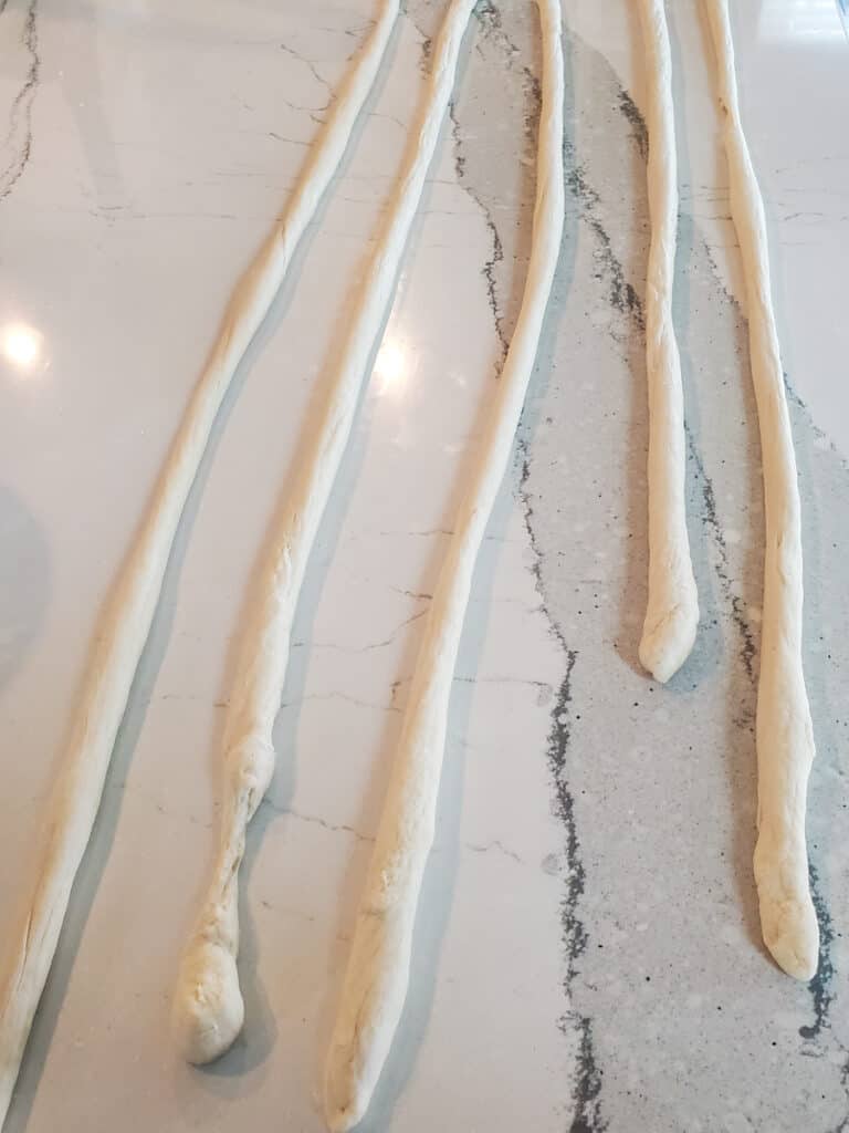 Pretzel dough rolled into long strands.