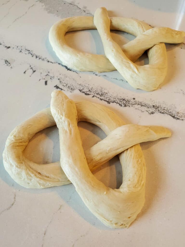 Dough being formed into pretzels.