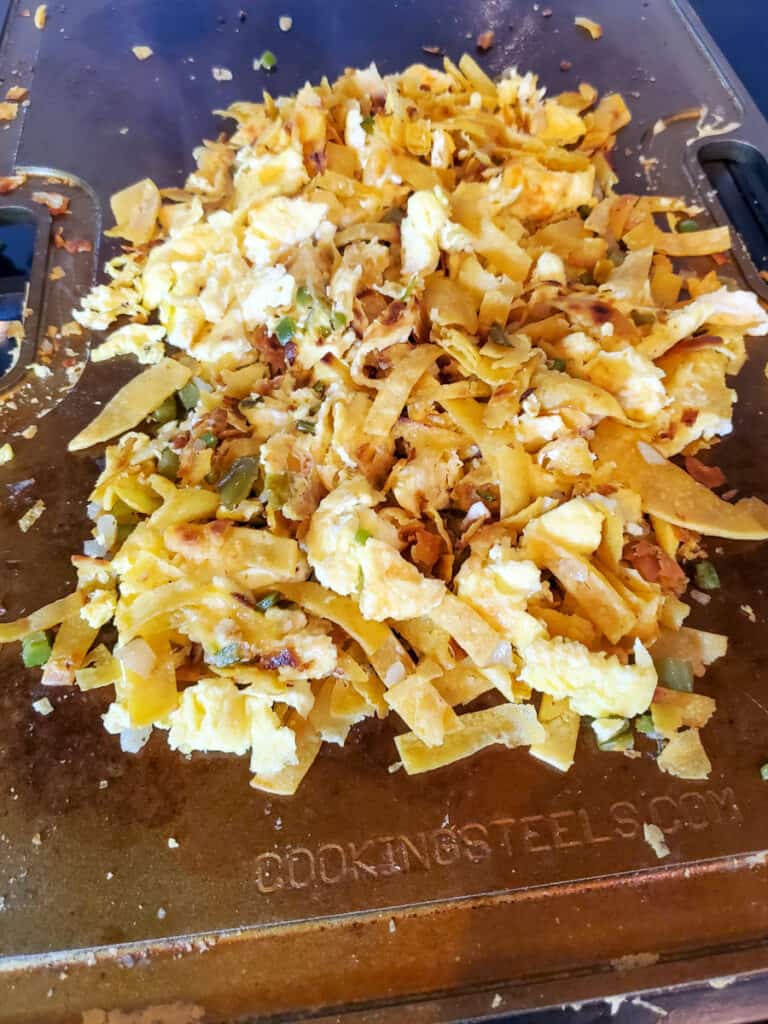 Authentic Mexican Migas cooking on a flat top.