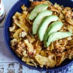 Authentic Mexican Migas in a bowl topped with avacado