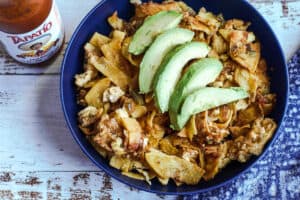 Authentic Mexican Migas in a bowl topped with avacado
