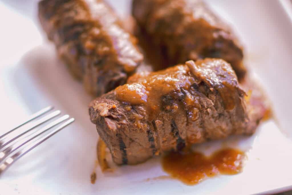German Beef Rouladen served with savory sauce.
