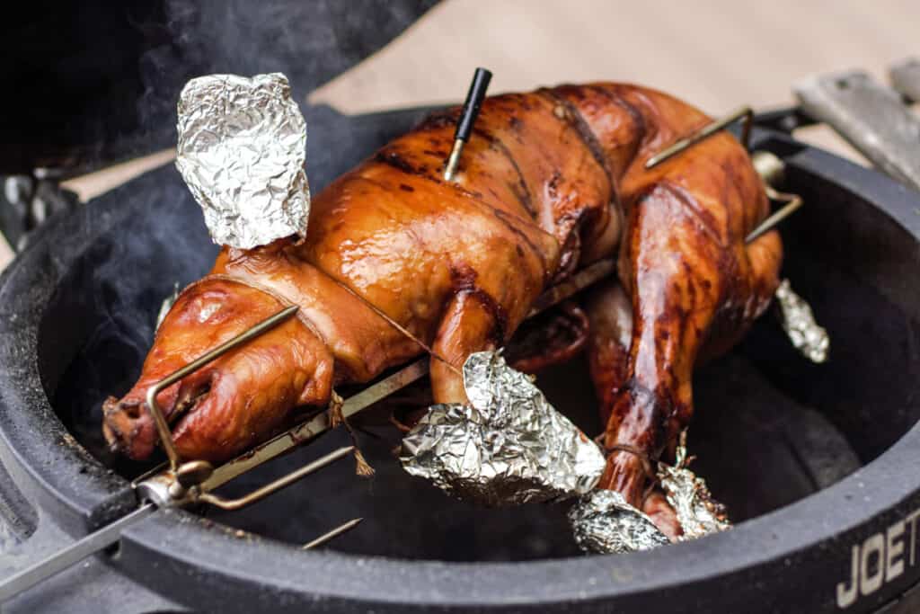 Suckling pig roasting on a rotisserie