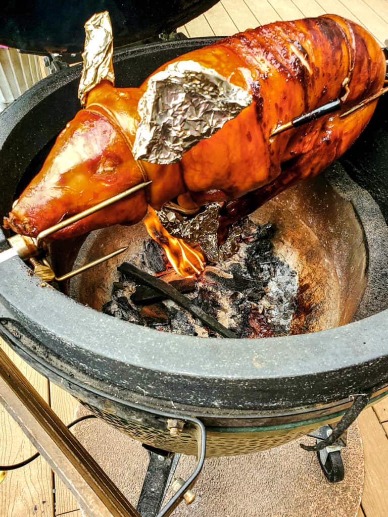 Cochiinillo Asado cooking over a live fire.