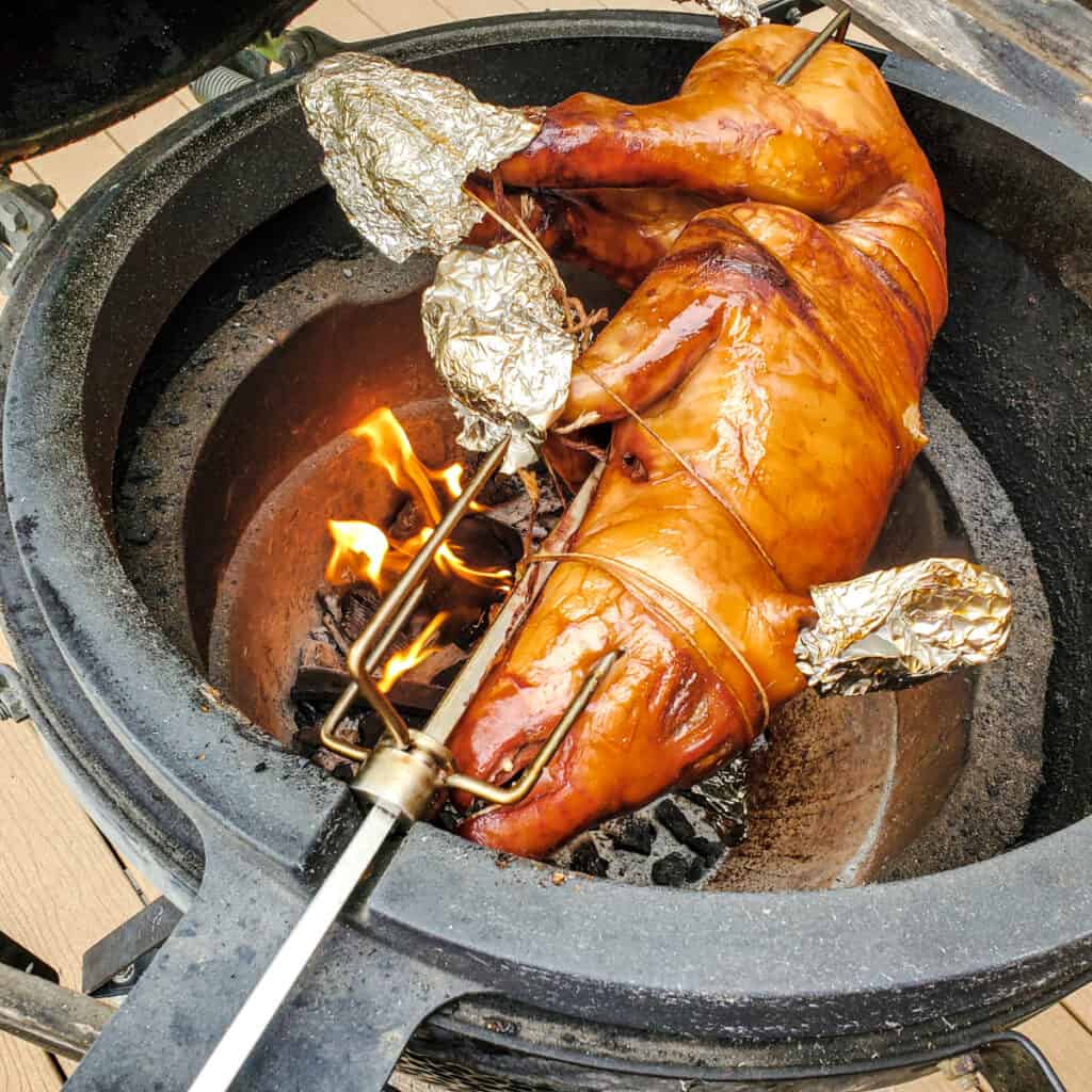 Roasting suckling pig on a spit.