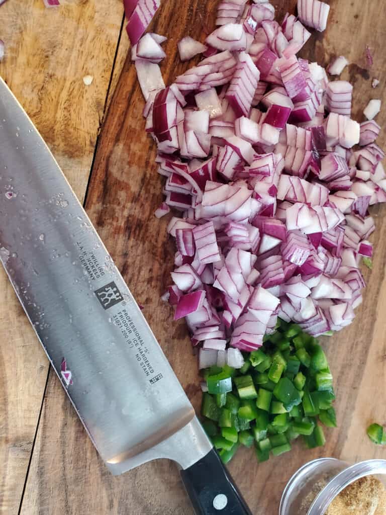 Diced onions and jalapenos on a cutting board.