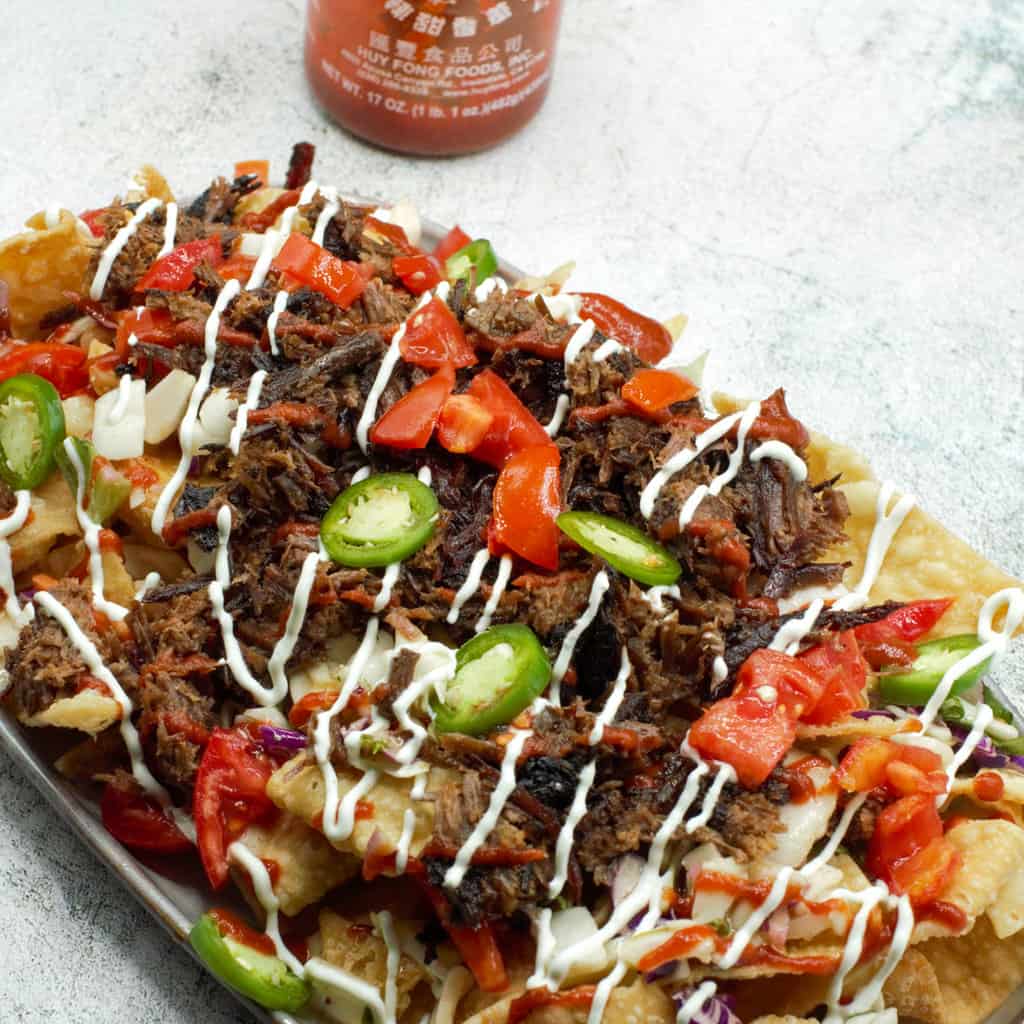 Asian inspired nachos with smoked beef and wasabi sauce.