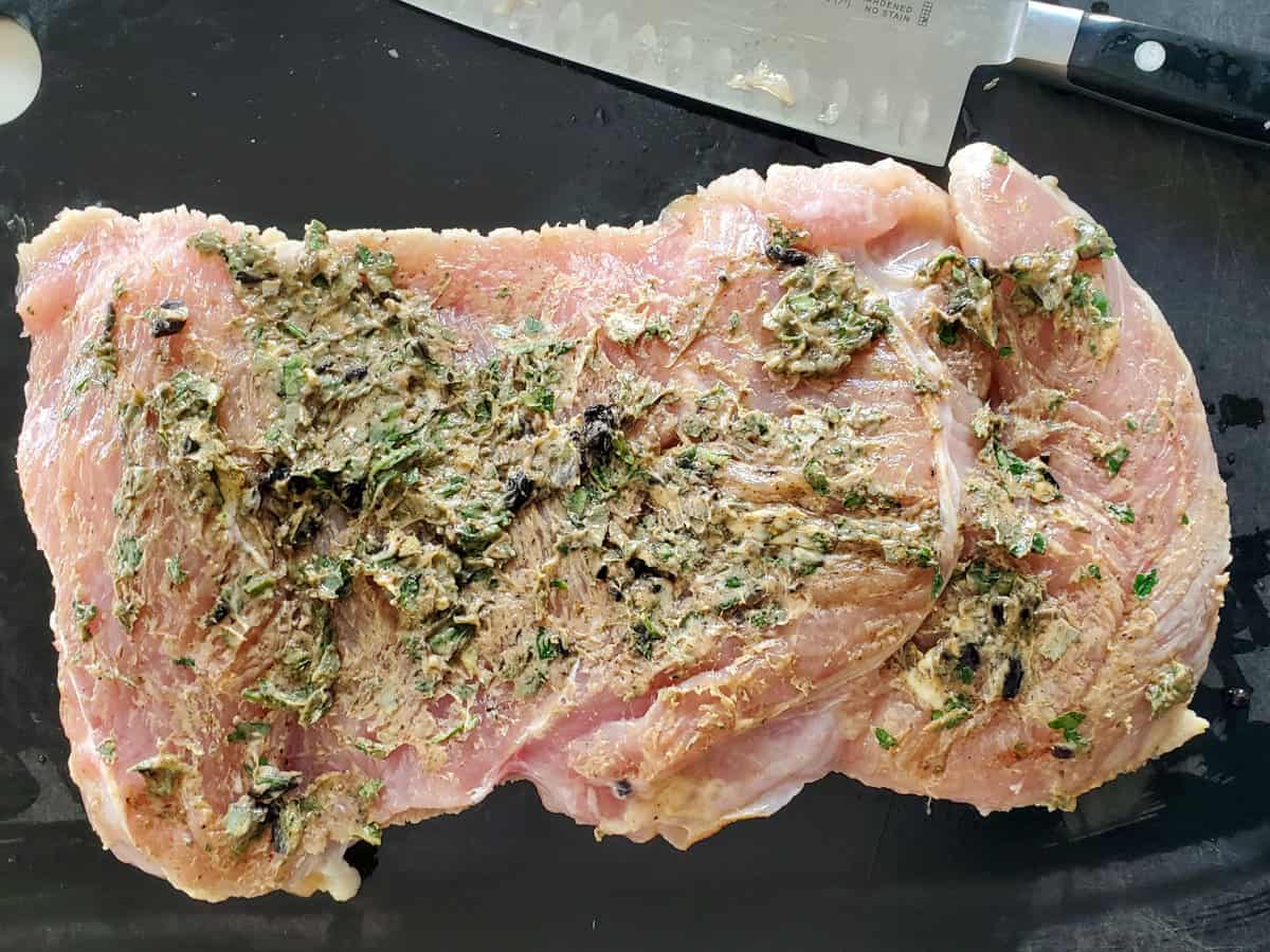 Herbed butter spread on a turkey breast for herb stuffed turkey breast,