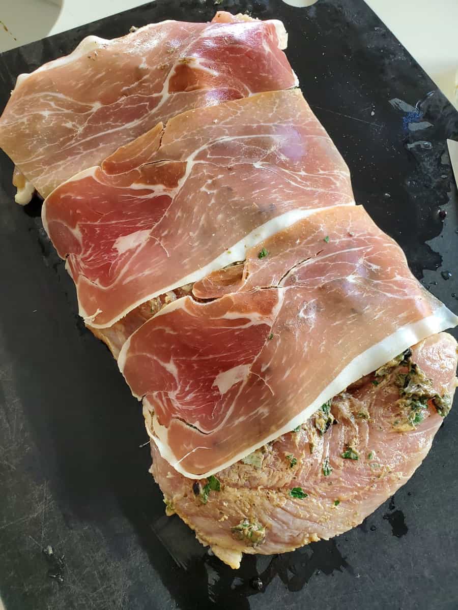 Slices of Prosciutto on a turkey roulade.