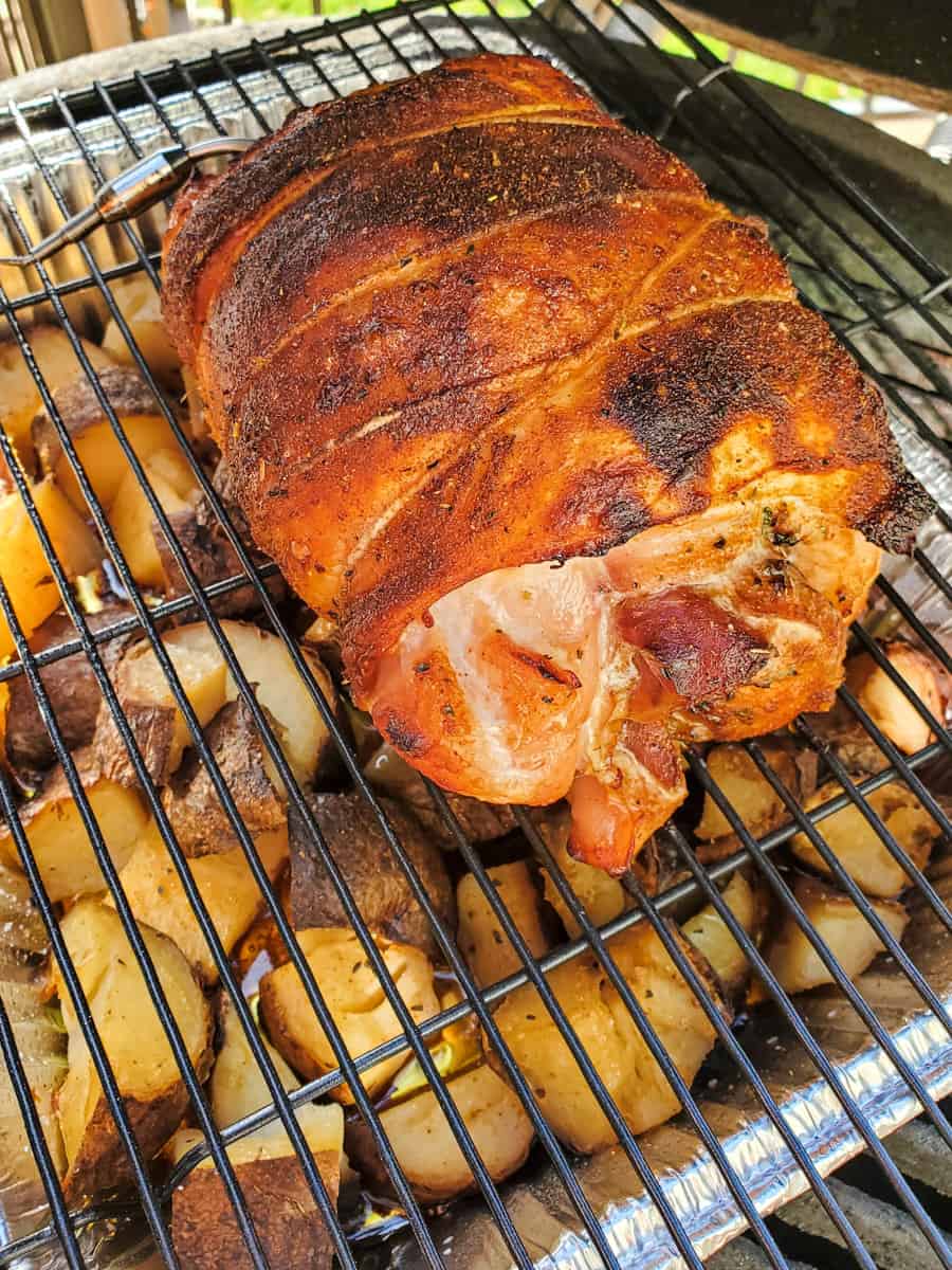 Herb stuffed turkey roulade on a smoker.