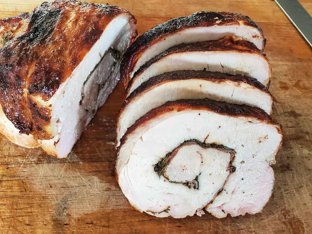 Sliced turkey roulade, stuffed with herbs and prosciutto.