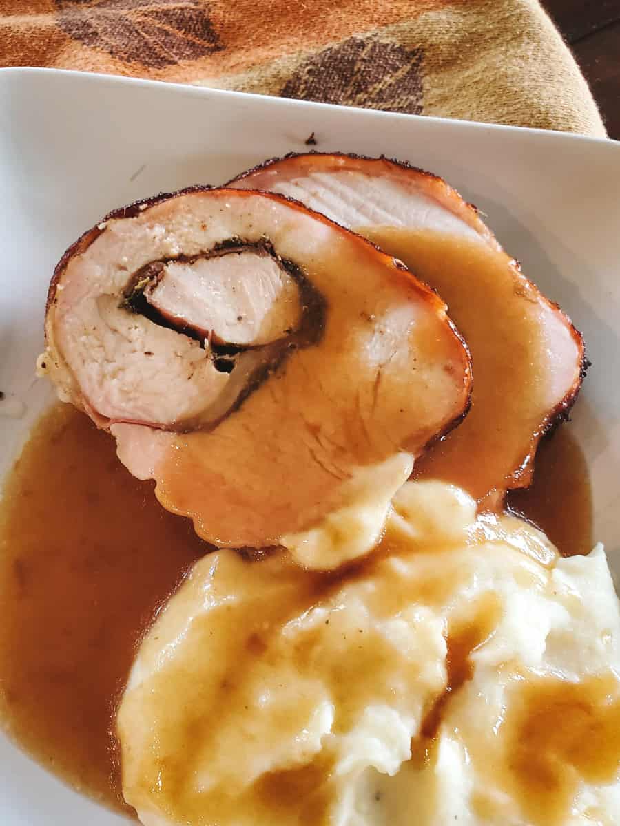 Herb and black garlic stuffed rolled turkey breast, served with gravy and mashed potatoes.