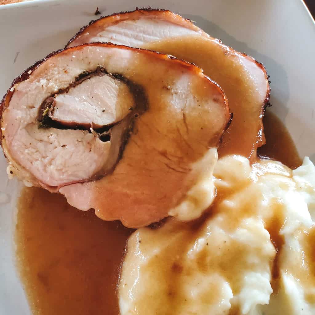 Smoked turkey roulade stuffed with herbs, garlic, and prosciutto.  Served with mashed potatoes and turkey gravy.