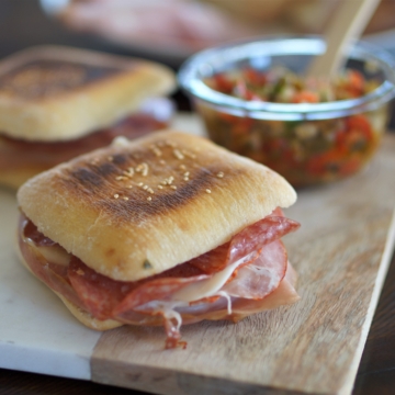 Grilled Muffaletta Sandwich on a cutting board.